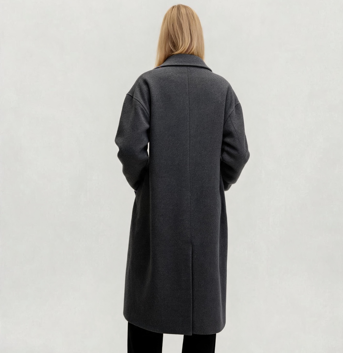 Back view of a woman wearing the Finlaine charcoal grey wool and cashmere long coat