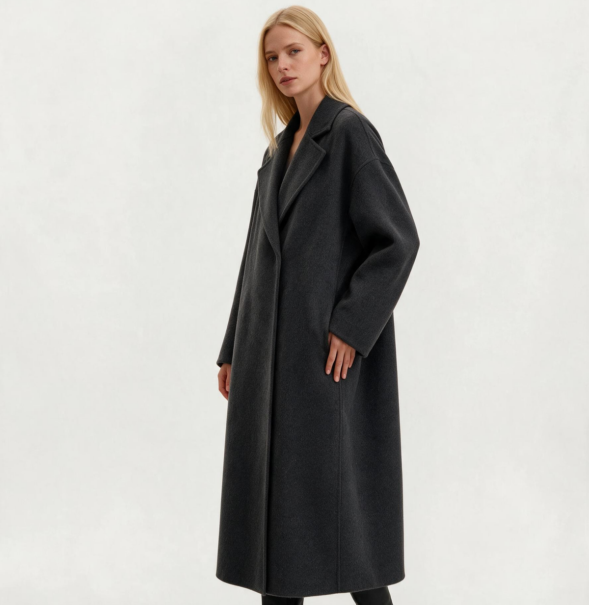 Side view of a woman wearing the Finlaine charcoal grey wool and cashmere long coat